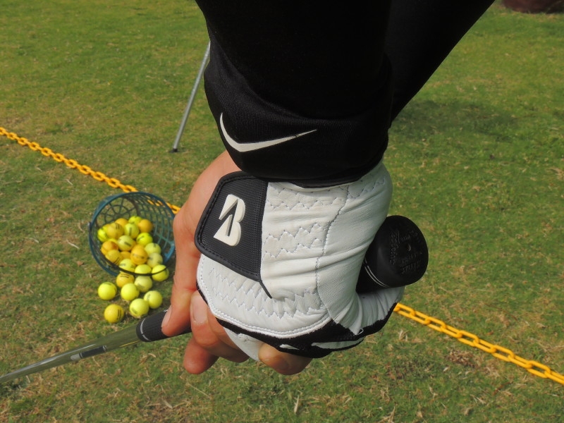 Golfer holding a club at a range 